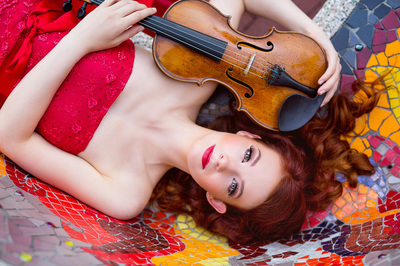 Chloé Trevor Woodard with violin on mosaic tiles
